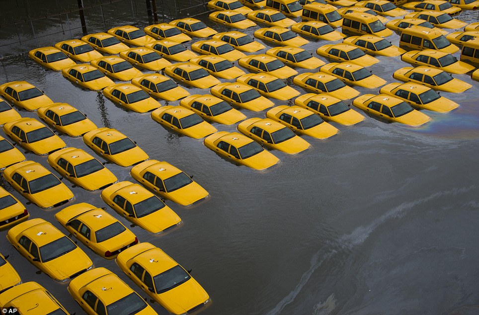 Fleet in the floods: Yellow cabs in a parking lot are surrounded by water after Superstorm Sandy struck Hoboken, New Jersey