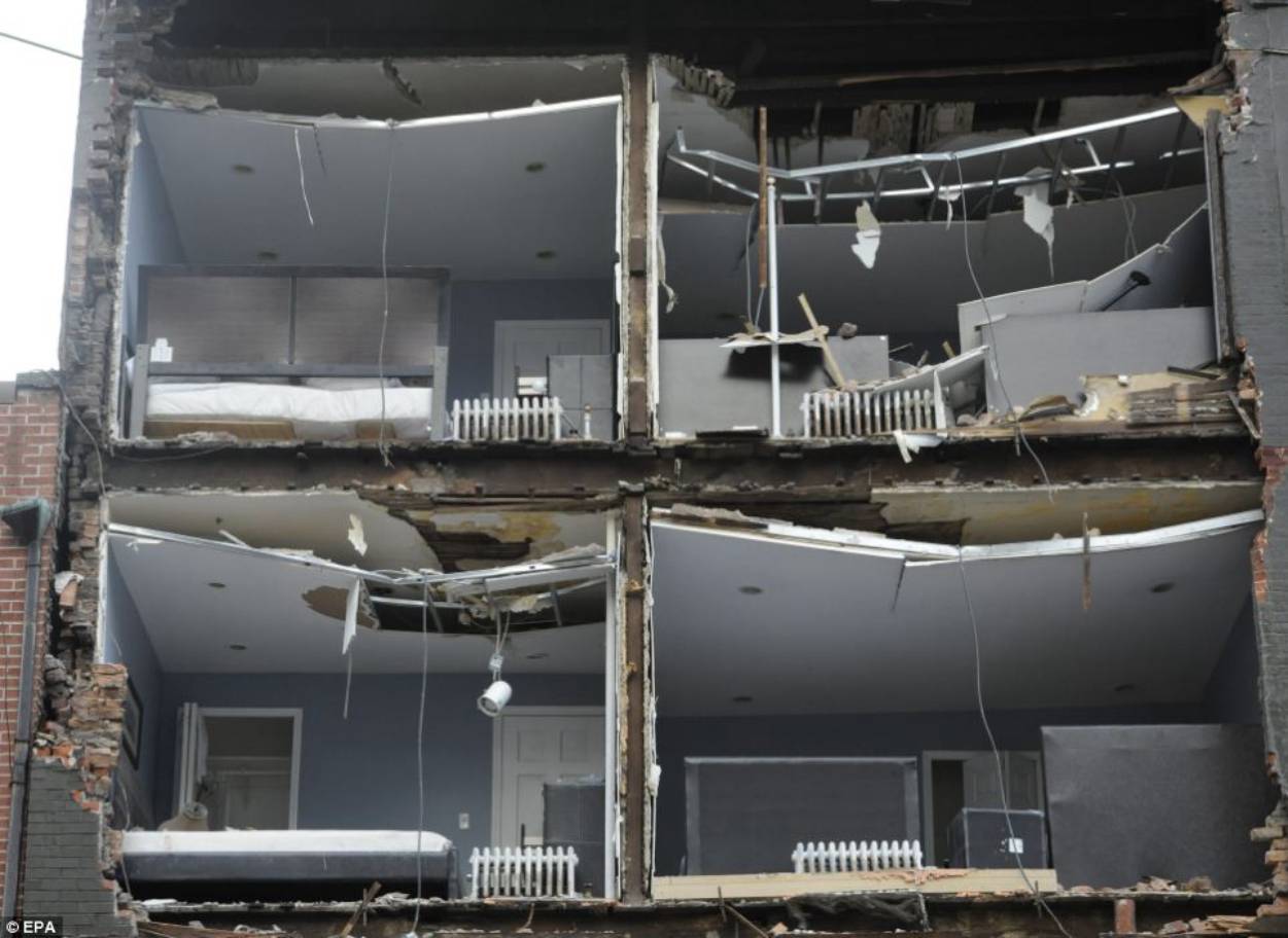 Damaged: A building that had its facade ripped off by Hurricane Sandy - beds and radiators can be seen in the block 
