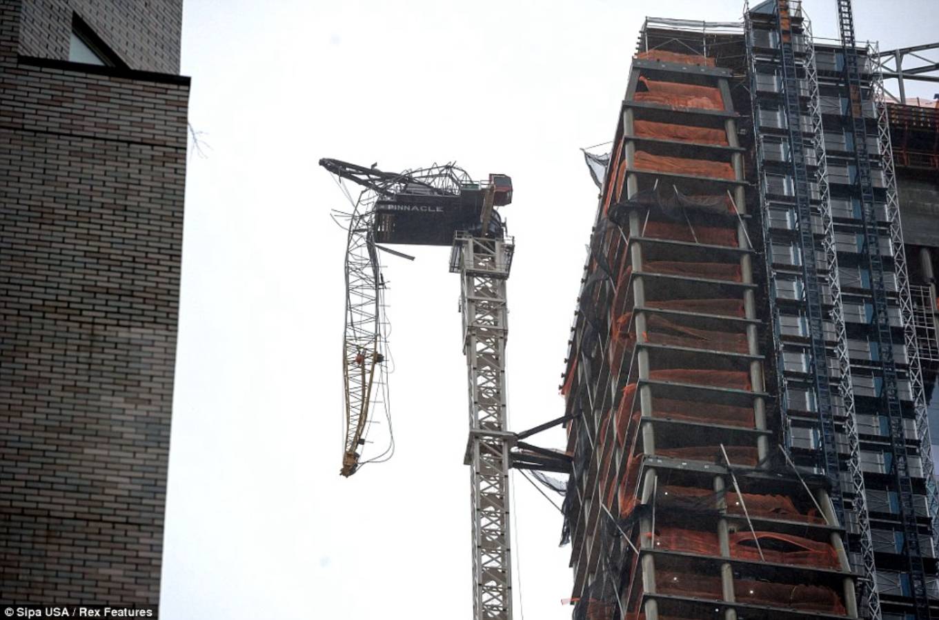 Precarious: A crane attached to One57, a luxury apartment tower under construction in midtown Manhattan, hangs down after partially collapsing amid gusts from Sandy