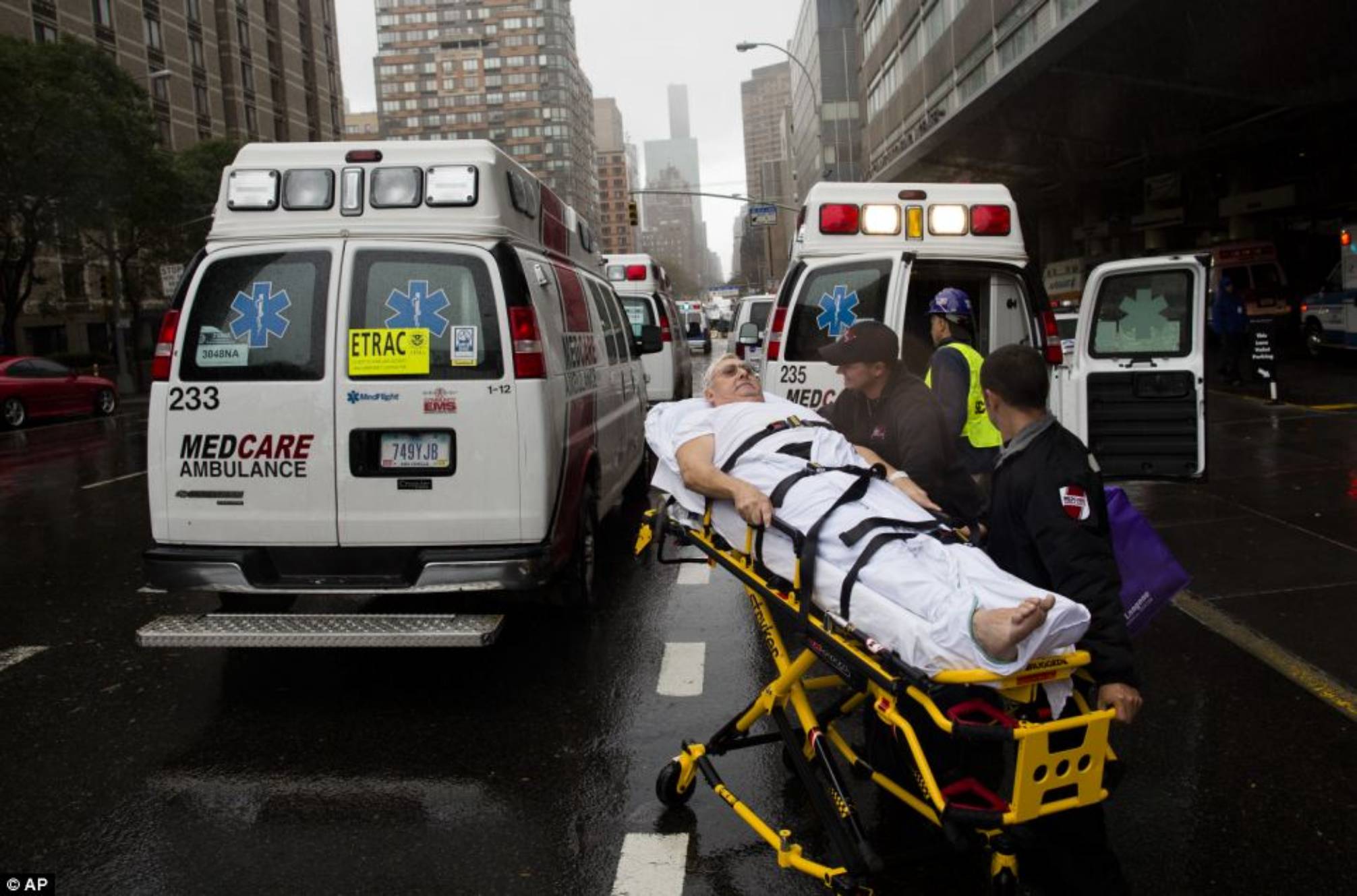 Treatment: A patient is wheeled to an ambulance in the rain during an evacuation of New York University Tisch Medical today